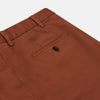 View 2 of product The Turnbull & Asser Orange Classic Chino Manson Trouser, crafted from cotton twill in Italy with a straight-leg fit and button-zip closure, is displayed flat against a plain white background.
