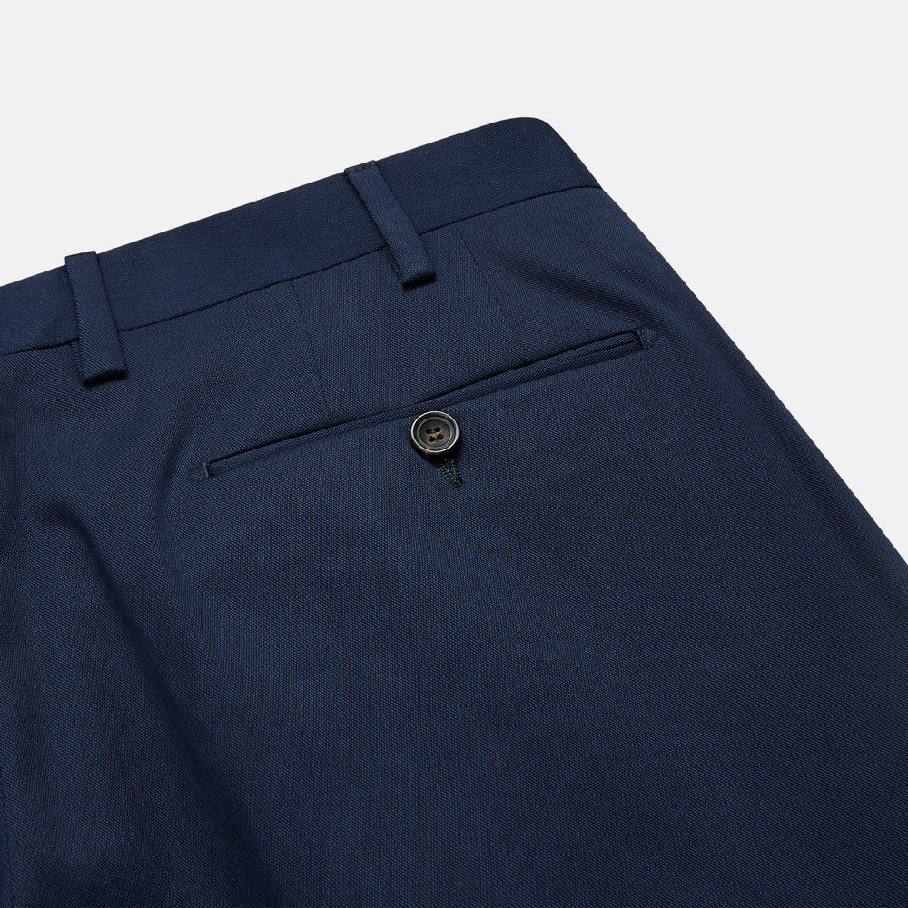 The Turnbull & Asser Navy Front Pleated Gerry Trouser is shown laid flat, featuring a classic straight leg, button and zip closure, belt loops, and crisp front pleats.