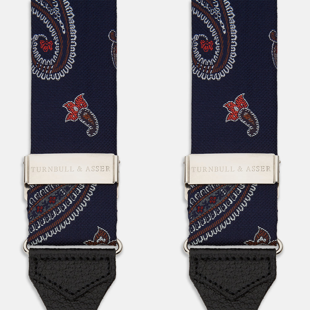 A pair of Navy Paisley Adjustable Silk Braces by Turnbull & Asser, featuring black leather loops and silver-tone adjusters, is displayed on a white background.
