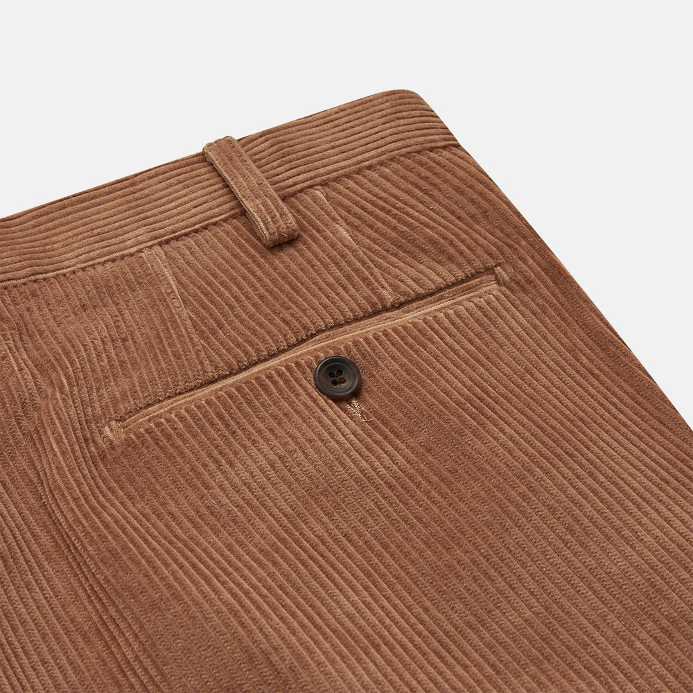 Turnbull & Asser’s Fawn Horizontal Cord Manson Trouser, tailored in Italy from brown cotton cord with straight legs, belt loops, and front button-zip closure, is shown laid flat on a white background.