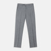View 2 of product A person wears Turnbull & Asser Grey Puppytooth Wool Manson Trousers, a white dress shirt with rolled-up sleeves, and black shoes, standing against a plain beige background.