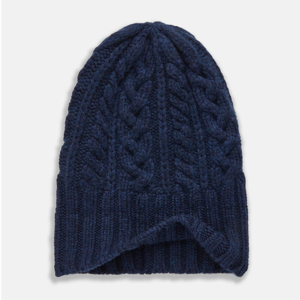 The Turnbull & Asser Navy Cashmere Cable Hat features a ribbed fold-over cuff and cable knit pattern, shown on a plain light background.