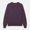 View 3 of product The Turnbull & Asser Plum Kingston Merino Crew Neck Jumper is a lightweight, long-sleeve sweater with ribbed cuffs and hem, shown flat on a white background. Its solid plum color and classic design offer timeless style.
