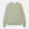View 1 of product The Light Green Kingston Merino Crew Neck Jumper by Turnbull & Asser is laid flat, displaying its classic design with ribbed cuffs, hem, and neckline.