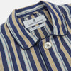 View 2 of product Turnbull & Asser's Blue Multi Stripe Cotton Modern Pyjama Set features a camp collar shirt with white buttons, front pocket, and long sleeves. Both pieces showcase classic blue and beige stripes for a timeless look.