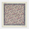 View 1 of product The White Floral Silk Pocket Square by Turnbull & Asser is crafted in England from silk, featuring a floral and paisley design in pink, purple, and gold with a navy border and the "TURNBULL & ASSER" logo in the corner.