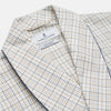 View 2 of product The Turnbull & Asser Brown Multi Check Cotton-Cashmere Gown features a shawl collar, front pocket, matching belt, and dark piping on the edges, sleeves, and pocket. Made in England and shown on a plain white background.