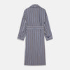 View 5 of product The Turnbull & Asser Blue Multi Stripe Cotton Gown features blue and white vertical stripes, long sleeves, a shawl collar, front pockets, and a matching waist tie, shown on a plain white background.