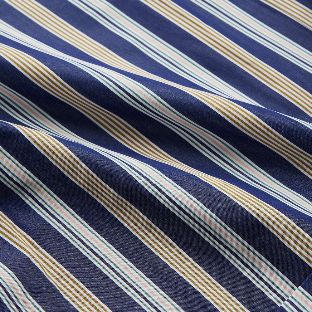 The Turnbull & Asser Blue Multi Stripe Cotton Gown features blue and white vertical stripes, long sleeves, a shawl collar, front pockets, and a matching waist tie, shown on a plain white background.