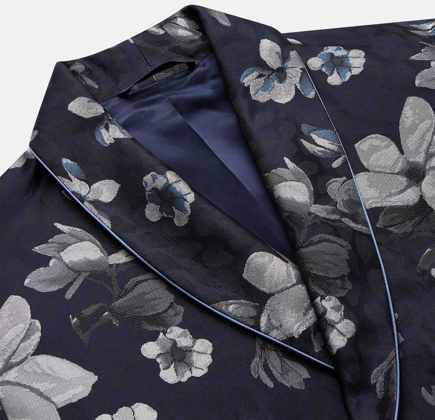 View 3 of product The Navy Floral Silk Jacquard Pierce Gown by Turnbull & Asser features a shawl collar, long sleeves, matching fabric belt, and elegant grey and blue floral design.