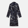View 1 of product The Navy Floral Silk Jacquard Pierce Gown by Turnbull & Asser features a shawl collar, long sleeves, matching fabric belt, and elegant grey and blue floral design.