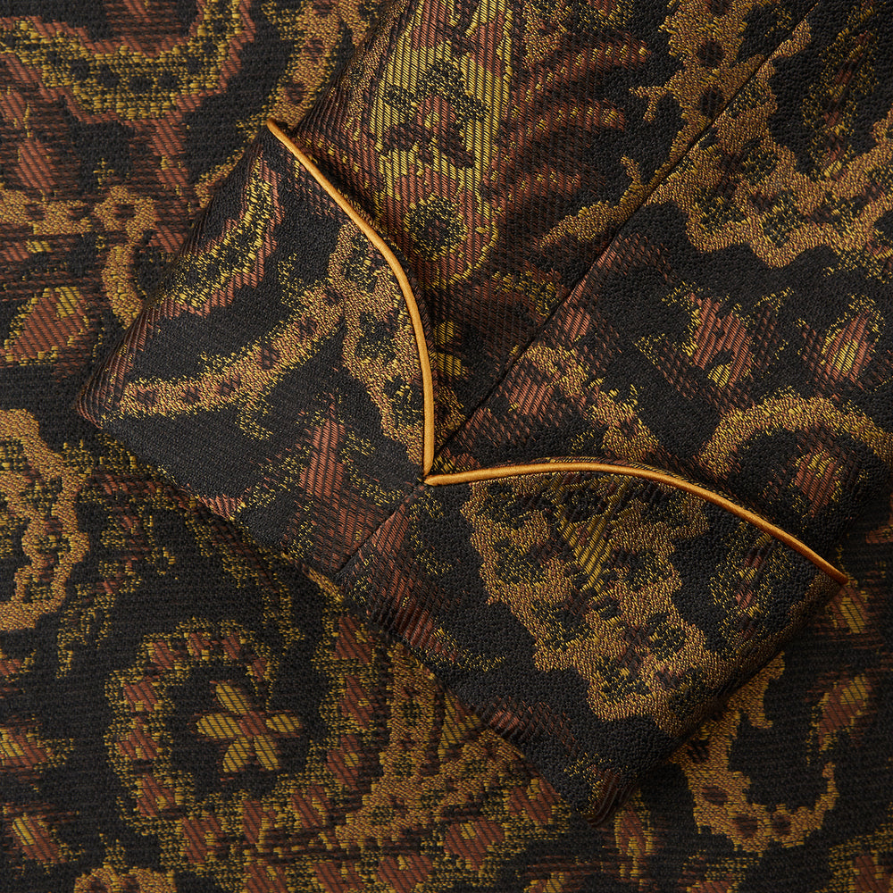 The Turnbull & Asser Gold Multi Floral Cotton, Wool & Silk Jacquard Pierce Gown features a shawl collar, matching belt, golden lining, and an elegant floral pattern in luxurious black, gold, and brown tones.
