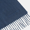 View 2 of product The Turnbull & Asser Slate Blue Purled Fringe Cashmere Scarf, neatly folded on a white background, is a stylish winter accessory.