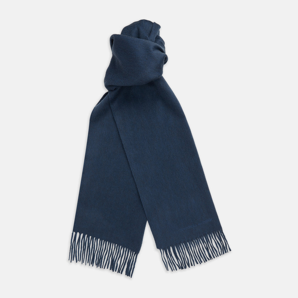The Turnbull & Asser Slate Blue Purled Fringe Cashmere Scarf, neatly folded on a white background, is a stylish winter accessory.