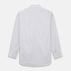 View 6 of product A man wearing the Turnbull & Asser Grey Multi Stripe Regular Fit Twill Shirt with T&A Collar and Double Cuffs stands against a beige background, one hand in his pocket, looking at the camera.