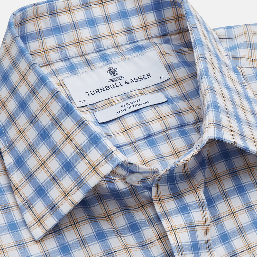 The Turnbull & Asser Blue Multi Check Regular Fit Shirt features a T&A collar, 3 button cuffs, a blue, tan, and white check pattern, and is crafted from Italian cotton poplin. It is shown laid flat on a white background.