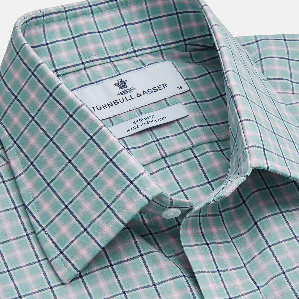 The Turnbull & Asser Green, Navy & Pink Check Regular Fit Shirt features a T&A collar, 3 button cuffs, and white buttons. Crafted from Italian cotton poplin, it’s displayed on a white background.