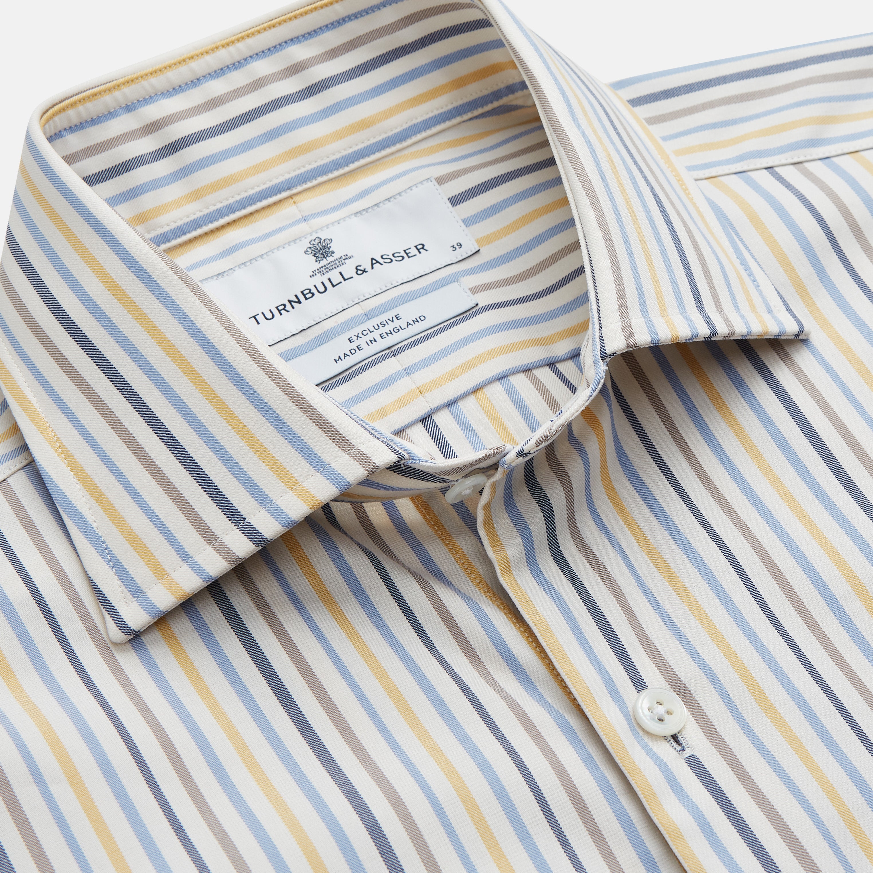 View 2 of product Turnbull & Asser’s Yellow Multi Stripe Tailored Fit Shirt features a Kent collar, blue, yellow, and white stripes on a light background, 2-button cuffs, and a curved hem for a refined look.