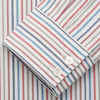 View 3 of product The Turnbull & Asser Burgundy Multi Stripe Tailored Fit Shirt features a Kent collar and 2 button cuffs, with vertical stripes on a light background. The shirt is neatly laid flat on a white surface.