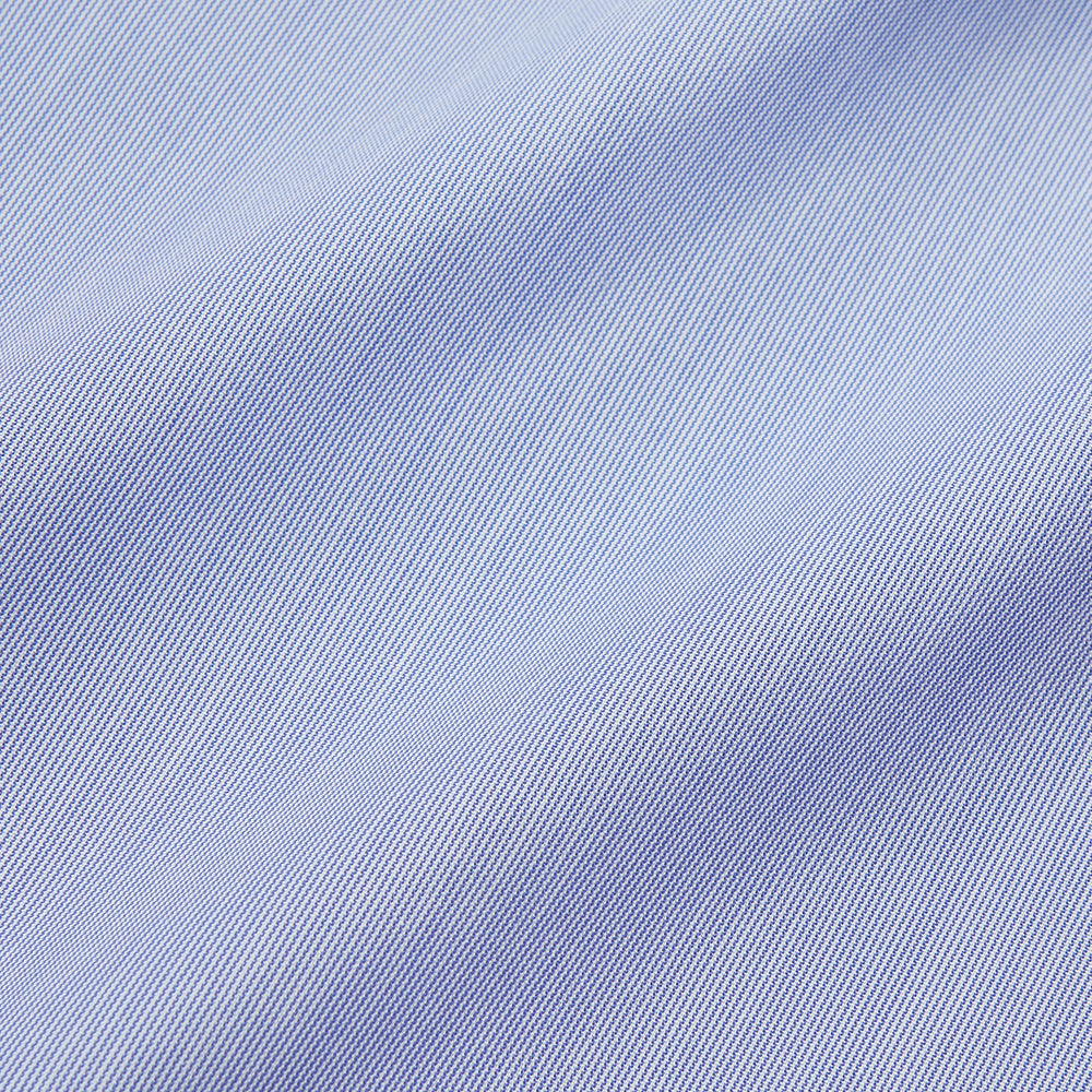 The Turnbull & Asser Pale Blue Weekend Fit Shirt with a Long Point collar and single button cuffs is laid flat on a white background.