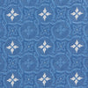 View 3 of product The Blue Multi Neat Silk Tie by Turnbull & Asser features a geometric pattern of white four-pointed shapes and circles, crafted in blue silk from the autumn-winter collection. Displayed rolled on a plain light background.