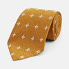 View 1 of product The Orange Multi Neat Silk Tie by Turnbull & Asser, from the autumn-winter collection, features a golden yellow geometric pattern on textured silk. Shown rolled on a white background, it pairs perfectly with bold signature shirts.