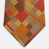 View 4 of product A close up of the Turnbull & Asser Orange Multi Pixel Silk Tie, featuring a refined checked design—ideal for elevating your autumn-winter style.