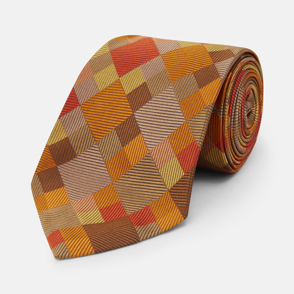 A close up of the Turnbull & Asser Orange Multi Pixel Silk Tie, featuring a refined checked design—ideal for elevating your autumn-winter style.