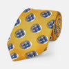 View 1 of product A rolled-up Turnbull & Asser Gold Shadow Spot Printed Silk Tie, featuring blue and white circular patterns on fine Adamley Macclesfield silk, displayed against a white background.