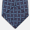 View 4 of product The Turnbull & Asser Navy & Blue Cross Silk Tie features a navy silk base with light blue and white geometric patterns and small white dots—ideal for elevating formal looks or pairing with signature shirts.