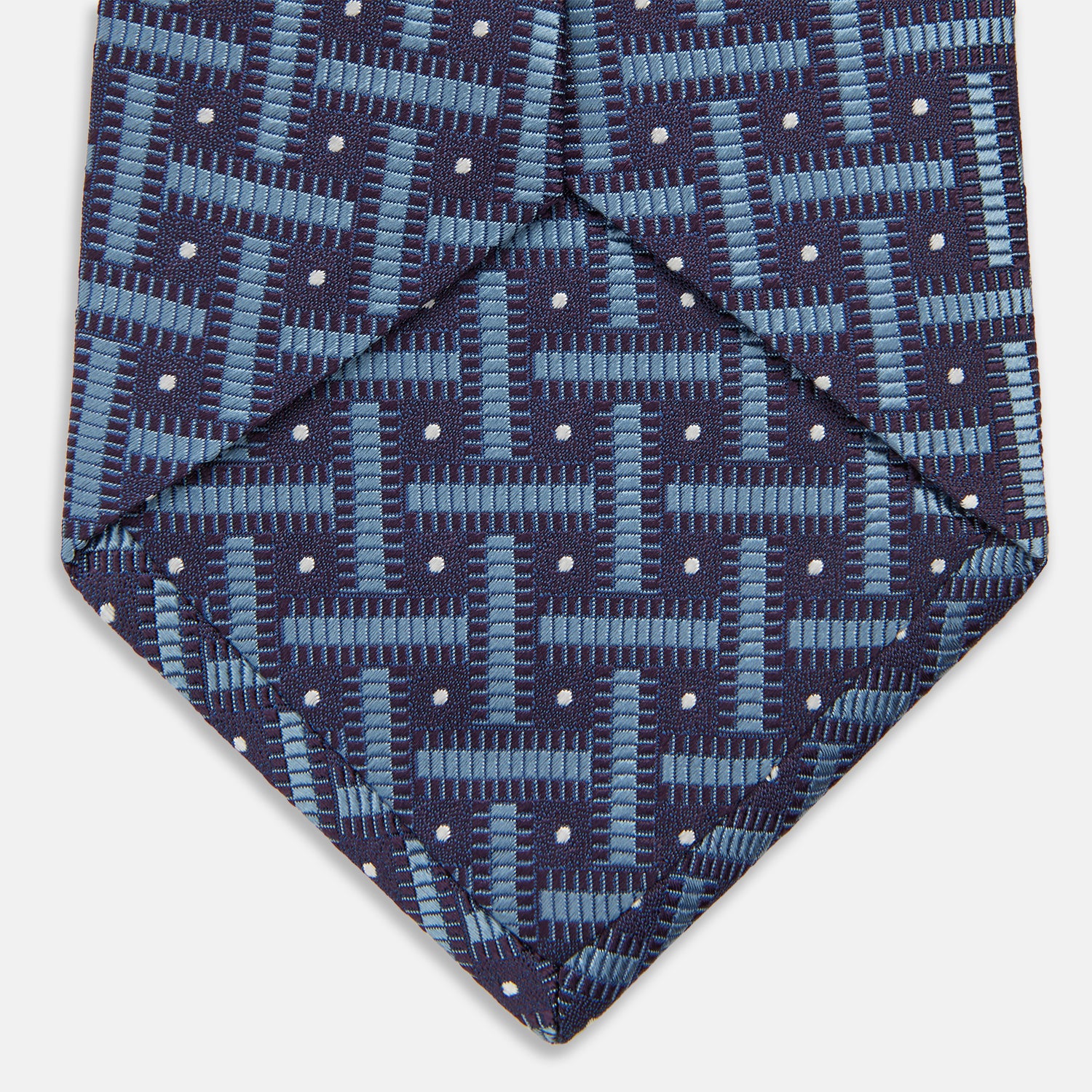 View 4 of product The Turnbull & Asser Navy & Blue Cross Silk Tie features a navy silk base with light blue and white geometric patterns and small white dots—ideal for elevating formal looks or pairing with signature shirts.