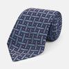 View 1 of product The Turnbull & Asser Navy & Blue Cross Silk Tie features a navy silk base with light blue and white geometric patterns and small white dots—ideal for elevating formal looks or pairing with signature shirts.