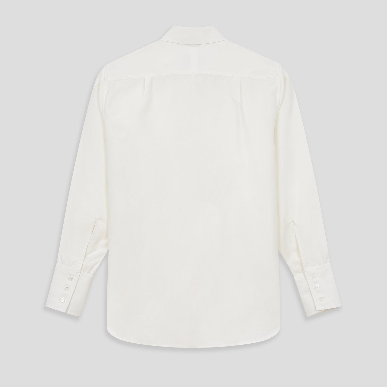 View 3 of product The Turnbull & Asser Turnbull and The Deck Cream Silk Romantic Shirt features long sleeves, a pointed collar, and elegant front ruffles, shown against a plain light gray background.