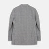 View 4 of product The Turnbull & Asser Grey Multi Check Linen Blend Barrington Blazer features notched lapels, a two-button single-breasted front, flap pockets, and buttoned cuffs, shown against a plain white background.