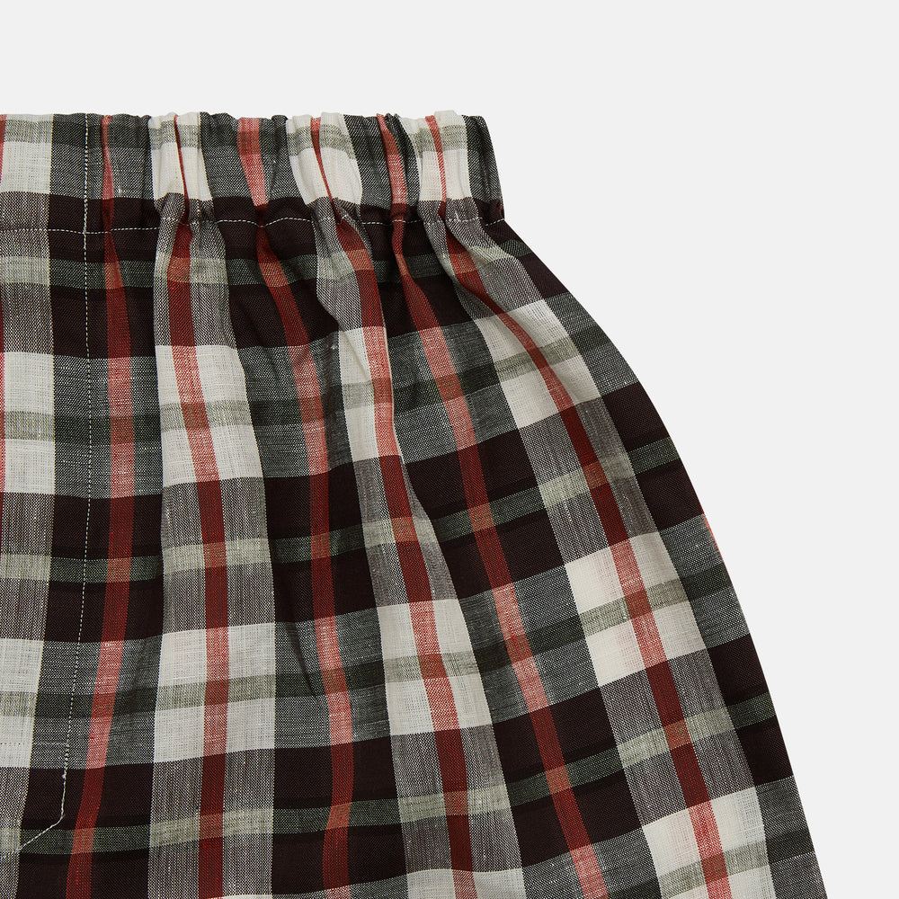 The Black Multi Check Linen Blend Godfrey Boxer Shorts by Turnbull & Asser feature an elastic waistband and a pattern of black, white, red, and beige checks. These luxury underwear essentials are displayed flat on a white background.