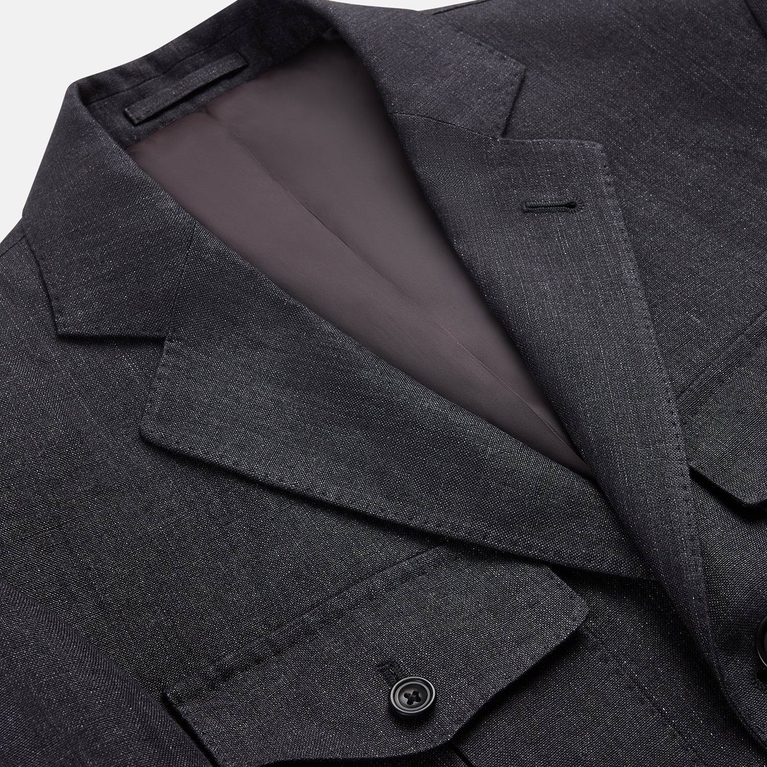 View 2 of product The Turnbull & Asser Charcoal Linen Safari Byron Jacket has a contemporary fit, notched lapel, front button closure, and four flap pockets—two chest and two waist—shown on a plain white background.