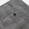 View 2 of product The Turnbull & Asser Grey Multi Check Linen Blend Darlington Trousers, featuring a straight-leg cut, belt loops, front zipper, and pressed center creases, are laid flat on a light gray background.