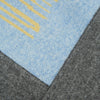 View 5 of product The Pale Blue Wool and Cashmere Lily Blanket by Turnbull & Asser features abstract, hand-drawn designs in blue, yellow, and gray on a white background.