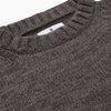 View 2 of product The Turnbull & Asser Fallow Wool and Cotton Blend Lewis Guernsey Jumper is a plain, long-sleeved dark gray knit with ribbed crew neck, cuffs, and hem, shown laid flat on a white background.