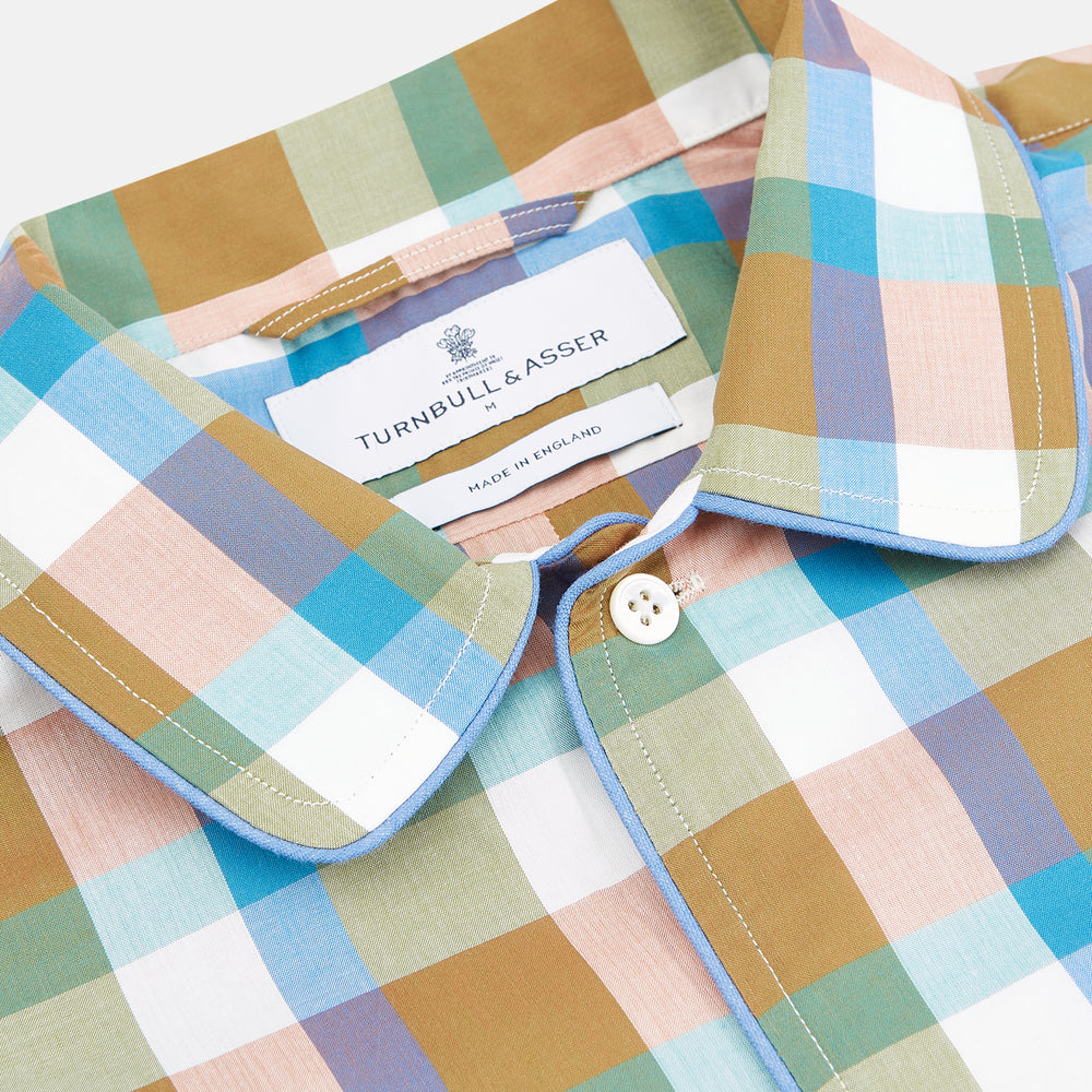 The Green and Pink Multi Check Linen Blend Sussex Nightshirt by Turnbull & Asser is a soft, long-sleeved sleepwear piece with a colorful plaid pattern, button-down front, chest pocket, and rounded hem—ideal as stylish luxury nightwear.