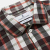 View 2 of product The Black Multi Check Linen Blend Sussex Nightshirt by Turnbull & Asser features a red, black, and white check pattern, button-down front, chest pocket, curved hemline, and brings a luxurious touch to classic sleepwear style.
