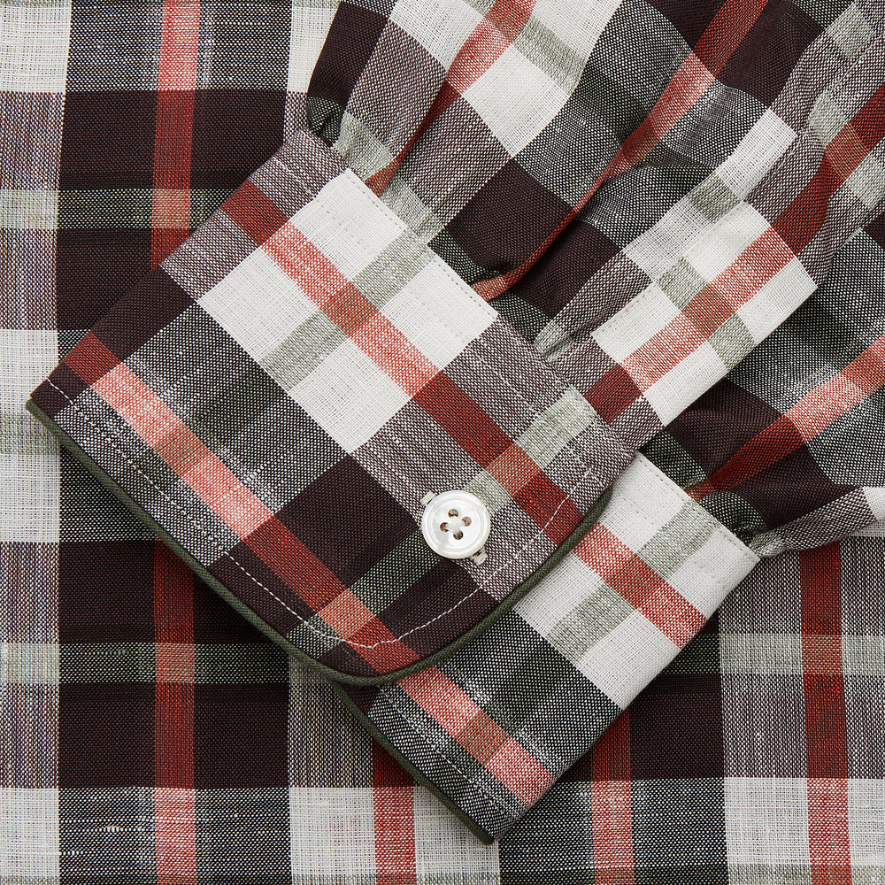 The Black Multi Check Linen Blend Sussex Nightshirt by Turnbull & Asser features a red, black, and white check pattern, button-down front, chest pocket, curved hemline, and brings a luxurious touch to classic sleepwear style.