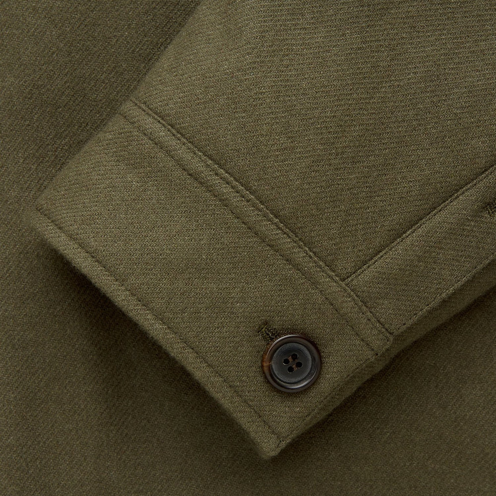 The Green Quilted Cashmere Amhurst Overshirt by Turnbull & Asser features a collar, long sleeves, button-flap chest pockets, and thermo-regulating graphene wadding. Displayed on a plain white background.