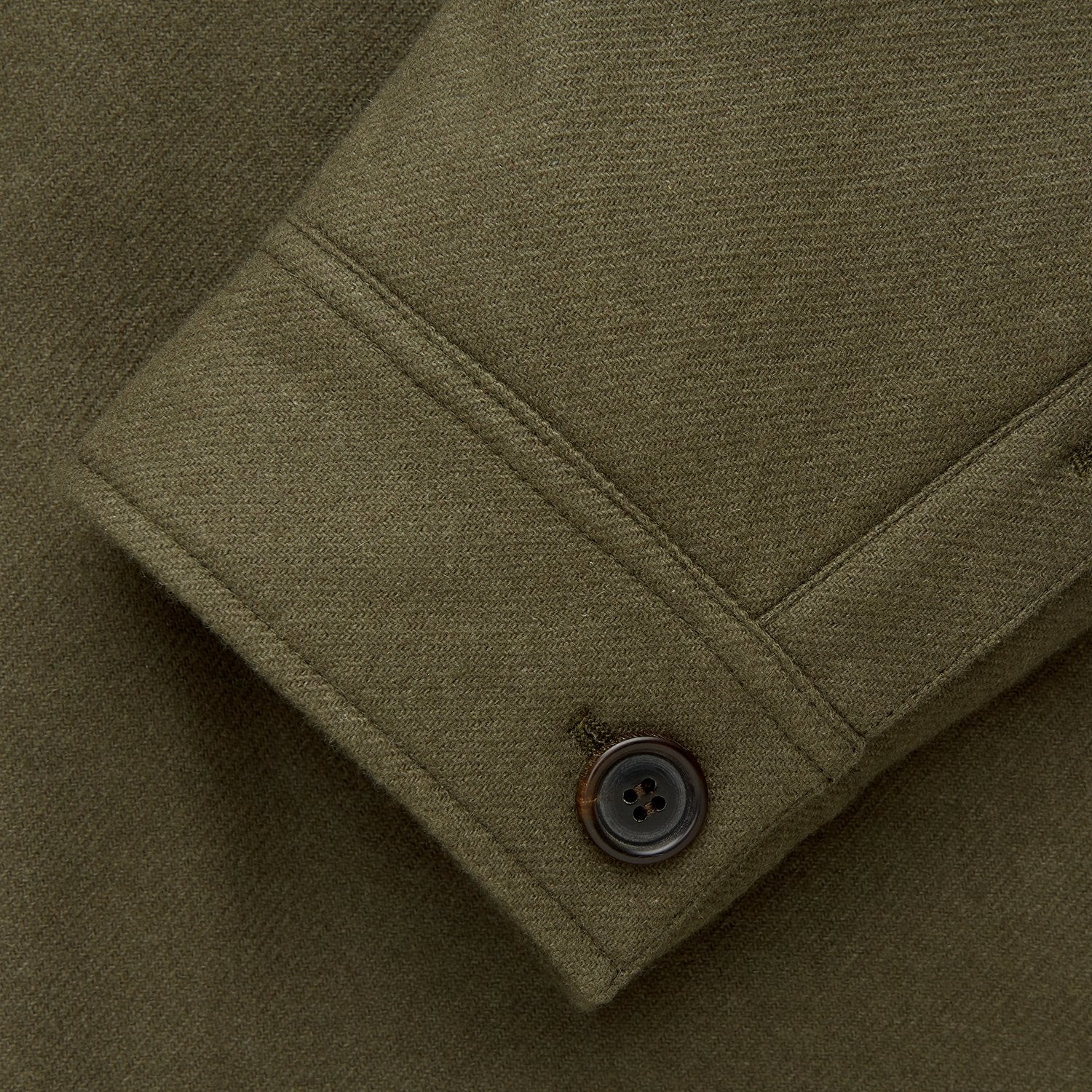View 9 of product The Green Quilted Cashmere Amhurst Overshirt by Turnbull & Asser features a collar, long sleeves, button-flap chest pockets, and thermo-regulating graphene wadding. Displayed on a plain white background.