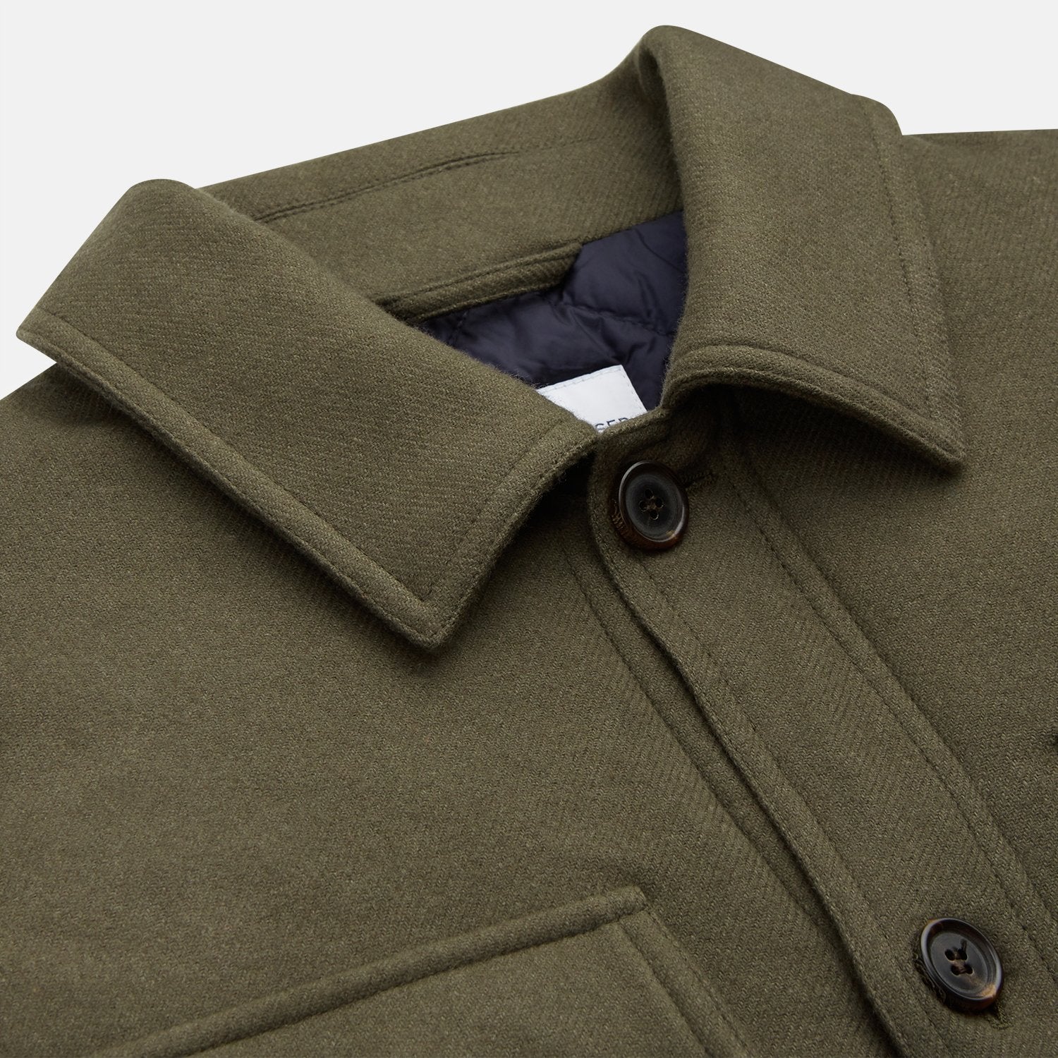 View 8 of product The Green Quilted Cashmere Amhurst Overshirt by Turnbull & Asser features a collar, long sleeves, button-flap chest pockets, and thermo-regulating graphene wadding. Displayed on a plain white background.