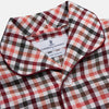 View 4 of product The Turnbull & Asser Green Multi Check Linen Blend Quin Pyjama Set, featuring a long-sleeve button-up shirt and pants with green multi check pattern and adjustable tie-waist, is laid flat on a white background.