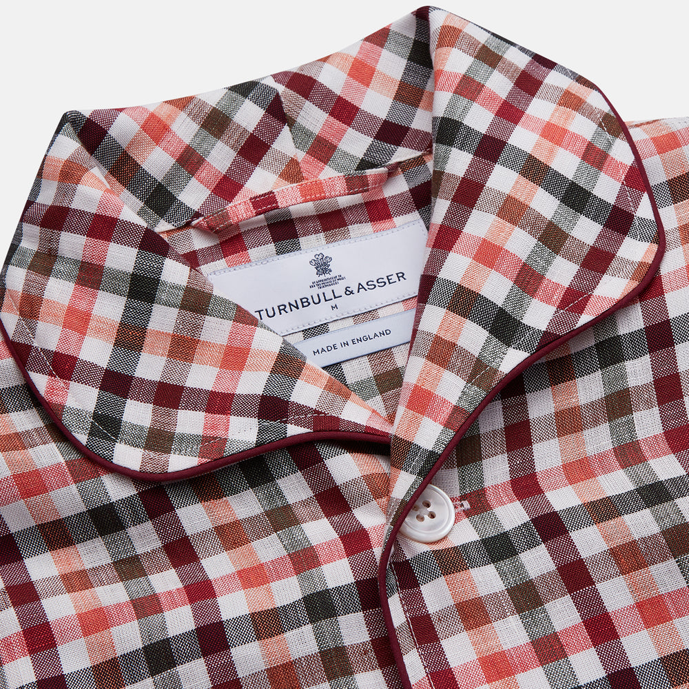 The Turnbull & Asser Green Multi Check Linen Blend Quin Pyjama Set, featuring a long-sleeve button-up shirt and pants with green multi check pattern and adjustable tie-waist, is laid flat on a white background.