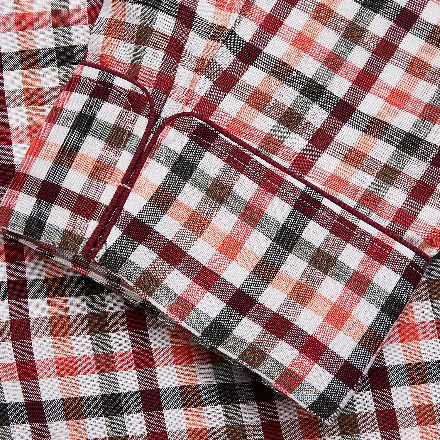View 3 of product The Turnbull & Asser Green Multi Check Linen Blend Quin Pyjama Set, featuring a long-sleeve button-up shirt and pants with green multi check pattern and adjustable tie-waist, is laid flat on a white background.