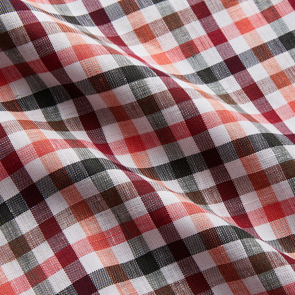 The Turnbull & Asser Green Multi Check Linen Blend Quin Pyjama Set, featuring a long-sleeve button-up shirt and pants with green multi check pattern and adjustable tie-waist, is laid flat on a white background.