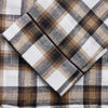 View 2 of product The Turnbull & Asser Brown Multi Check Linen Hyde Pyjama Set features a button-up, long-sleeve top and pants with a brown, black, and white plaid pattern, shown on a white background.